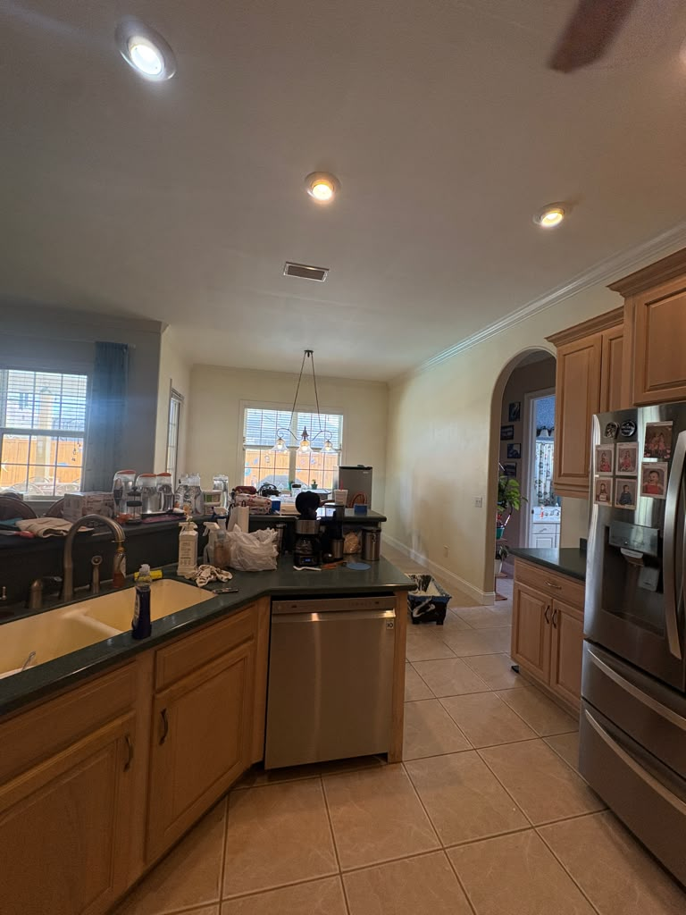 Open kitchen and dining after — walls brought to a smooth, bright painted finish